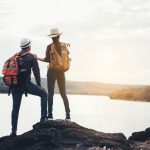 Couple Of Tourists With Backpacks on mountain